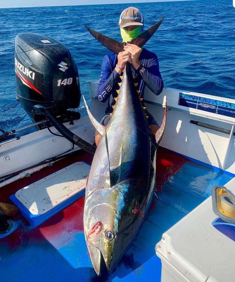 sitting in the boat with a big tuna