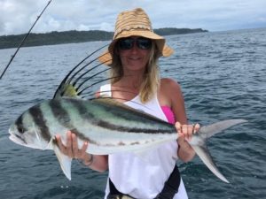 girl with roosterfish above water