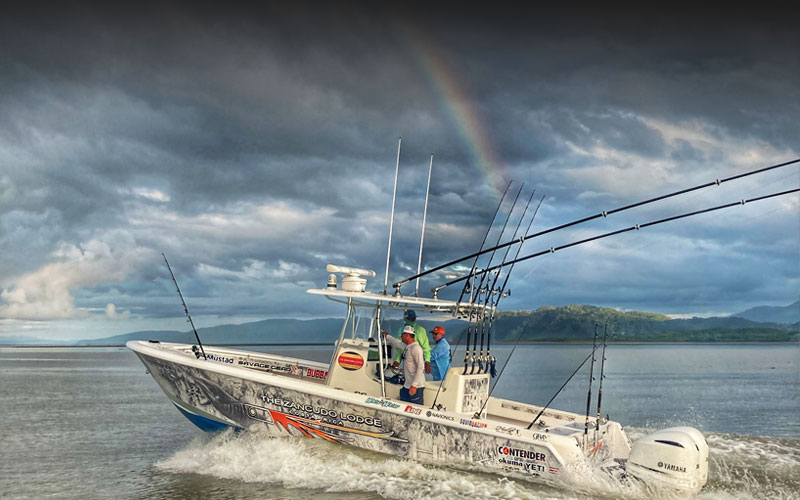 Contender boat under rainbow in Costa Rica